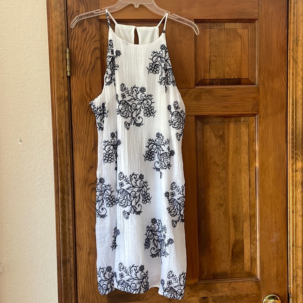 White gauze with navy blue embroidery. Fits like an XL